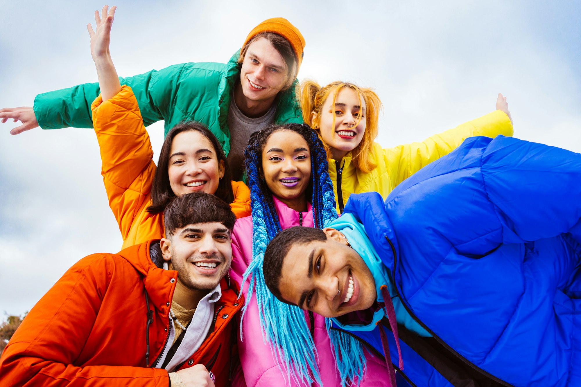 Multiracial group of young friends meeting outdoors in winter